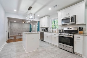 Kitchen leads to the second living room facing the backyard.