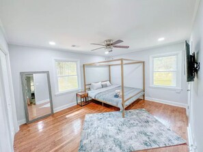Our bright master bedroom features a king bed, large mirror and closet.