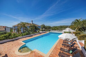 The Manoir and Pool with sun loungers