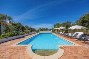Pool with sun loungers