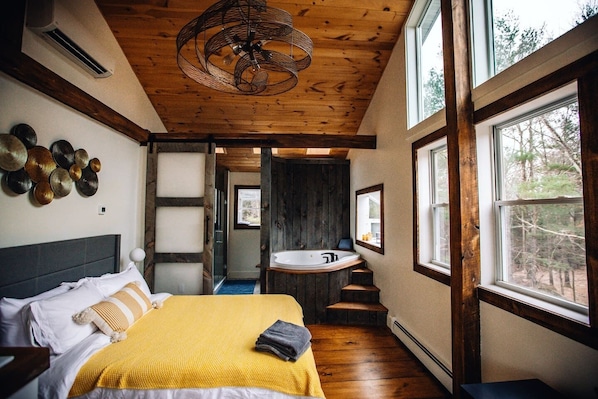 Master bedroom has beautiful decor and private jacuzzi encapsulated in weathered rustic wood