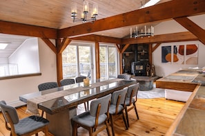 Dining area has a huge table that can easily fit 8 people. With the view to the woodstove of course. Imagine dimming the lights and having a nice family dinner with the fire on the background.