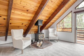 Primary bedroom features a unique and cozy sitting area and a private balcony.