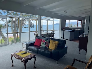 Expansive lounge and kitchen with panoramic views of the bay.