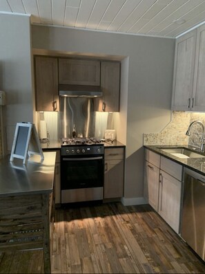 Kitchen with full sized appliances and all the necessities. 