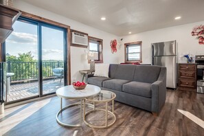 Living Room with Private Balcony, TV, Queen Pull Out Sofa, Electric Fireplace