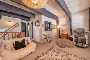 Loft area with massage chair and arcade