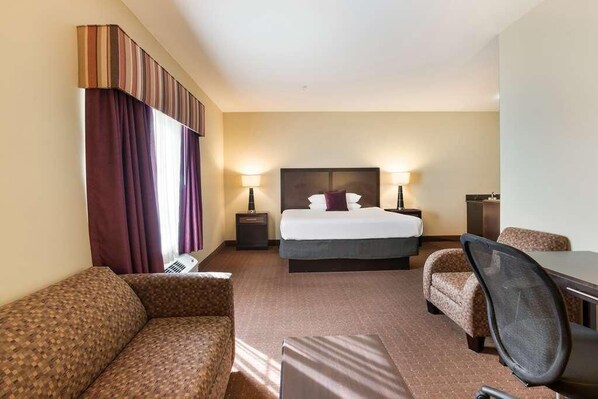 A comfortable unit with a king size bed and a space for your laptop.