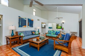 Large living room with 70" wall-mounted TV. 
