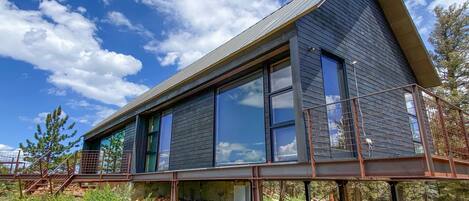 The elevated deck is a heavenly relaxation space surrounding the structures.