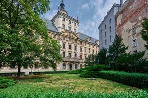 View of a beautiful, historic building surrounded by green areas.