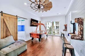 2nd Floor - Game Room with professional air hockey table, foosball table, and 2 wall-mounted arcades