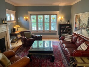 Large sitting room with beautiful stained glass windows. 