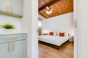 Spacious bedroom with a comfortable king-sized bed, rustic wooden ceiling, and modern decor, providing a cozy and relaxing atmosphere