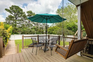 Private backyard deck with porch swing and outside dining.  Also has gas grill