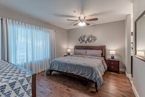 The primary suite features a king bed, smart TV, walk-in closet and en suite, newly remodeled bathroom.