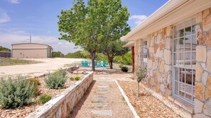 The fire pit is located just off of the side of the main home.