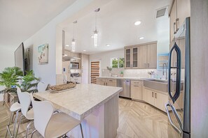 Countertop and Barstools connected to the kitchen.
