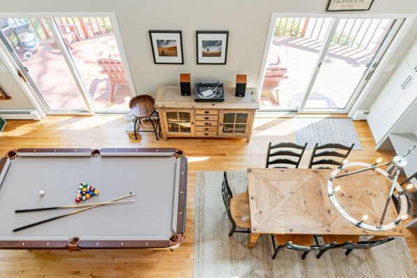 Loft view of the pool table and dining area