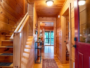 The entryway provides a first glimpse of the rustic charm of this beautifully constructed, hand stacked, solid wood log cabin.