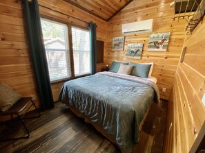 Comfy queen bed for a peaceful night's sleep after a long day of exploring the riverfront property, enjoying our tasting room, and indulging in our exceptional food!