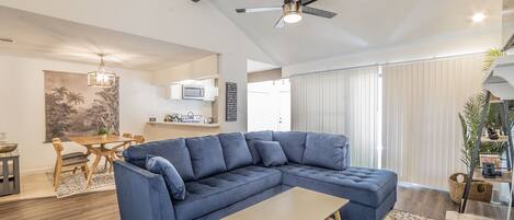 Open living space with brand new comfy sofa and 55 inch TV
