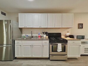 Indulge in the culinary arts with our fully-appointed kitchen, a symphony of gastronomic excellence featuring a gas stove, expansive fridge, and an array of culinary essentials. From bakeware to utensils, every accoutrement awaits to elevate your gastronomic endeavors.