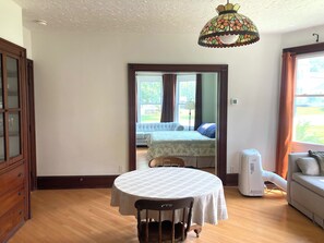 Dining Room: Pocket doors (shown fully open) lead into bedroom/living room