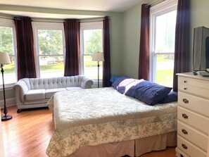 Bedroom/Living Room: king size bed, couch, dresser, smart TV 