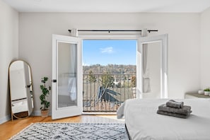 Master bedroom on 3rd floor opens to overlook the city.