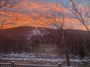 Beautiful sunset view of South Peak trails and Pemi River in early April