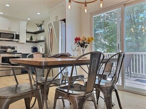 Savor meals and conversations in our elegant dining area with a stunning view of nature outside.