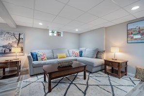 Basement family room area with games and lots of seating.