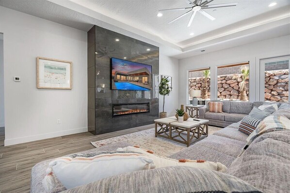 Large gorgeous family room with large sectional and fireplace