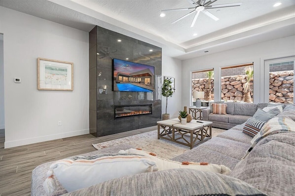 Large gorgeous family room with large sectional and fireplace