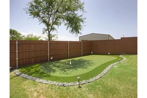 Sharpen your golf game on the 4 hole putting green!