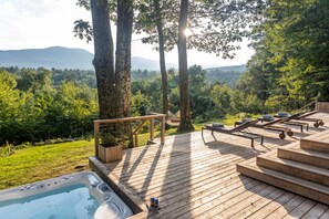 Hot tub and loungers with views of the mountains