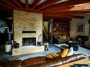 The main living space is in the round, with a massive central wood burning fireplace.