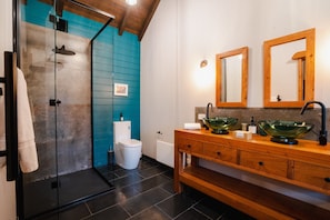 Bathroom with rain shower head, plush towels and Dyson hairdryer