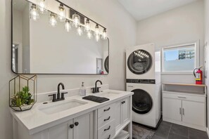 full bathroom with washer and dryer 