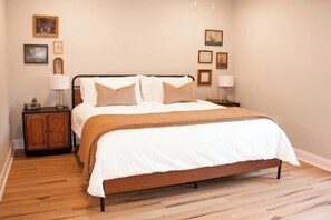 Primary bedroom has a comfortable king bed and dedicated workspace.