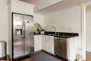Full kitchen w/ dishwasher, cook-top, oven, microwave, and refrigerator.