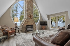 Gorgeous floor to ceiling fireplace creates an immaculate center to the main living room