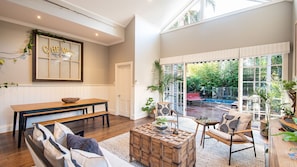 Living and dining leading out to decked back yard and heated plunge pool