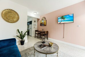 Living area, with a plush navy-blue couch and a flat-screen TV 