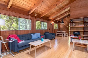 Open living space with sofa sleeper, fireplace, and Smart TV