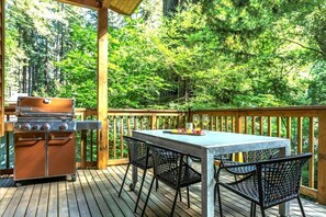 The front deck has a gas grill and outdoor dining