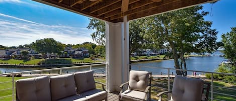 Cool breezes, fresh air, comfy and versatile seating on the spacious porch.  Perfect for relaxing, gathering, dining--you could spend all day here and watch the change of day go by.  Along with the ducks and geese on the lake!