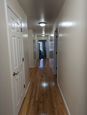 Gleaming hardwoods down the hall to the bedrooms and bathrooms.