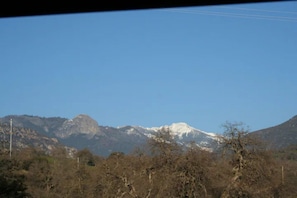 The winter view from the cabin porch with snow on the mountains.